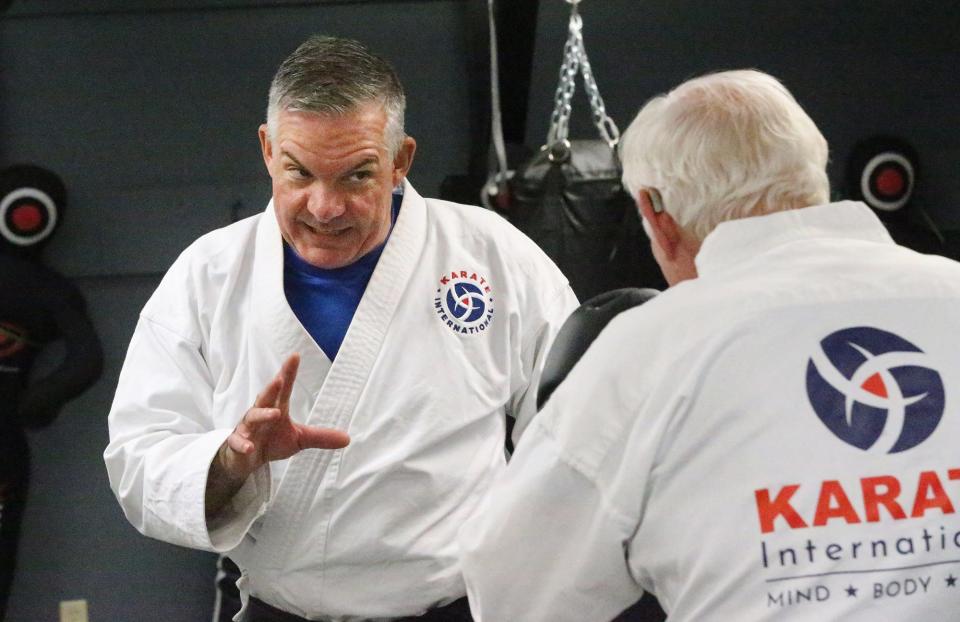 Karate International, based in Exeter, recently expanded its campus to Barrington. Its first adult student was 82-year-old Don Staton. Instructor John English works with him on offense and defense.