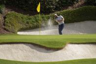 Scottie Scheffler hits from the bunker on the 12th hole during the first round at the Masters golf tournament at Augusta National Golf Club Thursday, April 11, 2024, in Augusta, Ga. (AP Photo/George Walker IV)