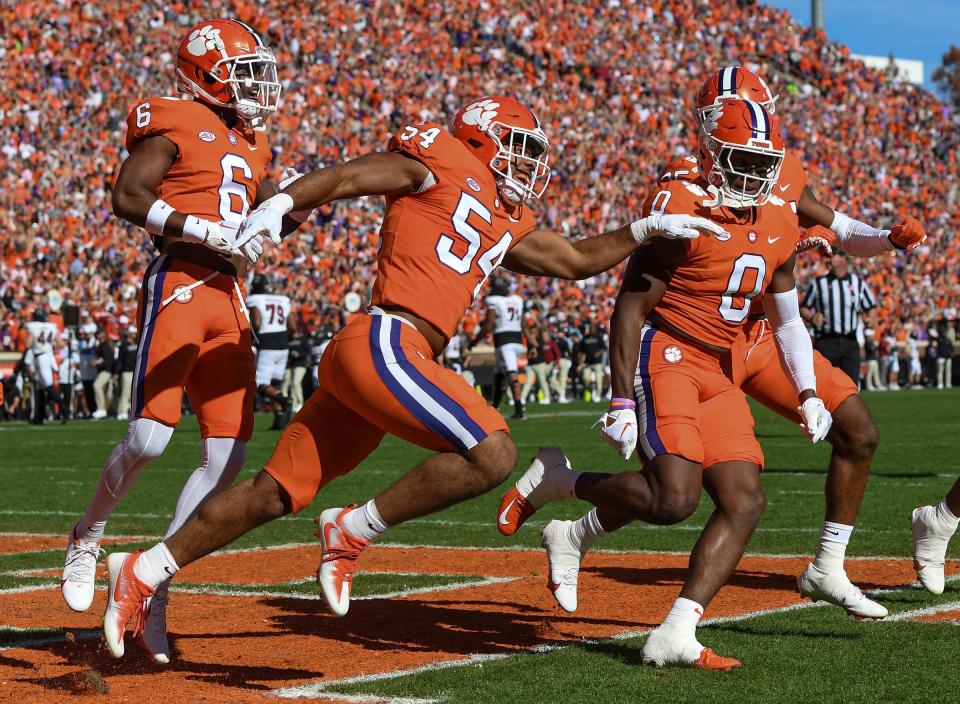 Clemson linebacker Jeremiah Trotter Jr. (54) celebrates intercepting a South Carolina quarterback Spencer Rattler (7) pass and running it in for a touchdown during the first quarter at Memorial Stadium in Clemson, South Carolina Saturday, Nov. 26, 2022.   