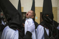 <p>A child cries as penitents from the Jesús en su Tercera Caída brotherhood take part in a procession in Zamora, Spain, April 14, 2014. (AP Photo/Andres Kudacki) </p>