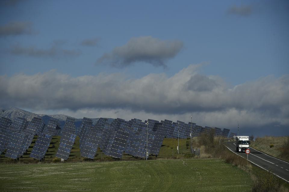 A truck moves down a road close to a solar park in Los Arcos, Navarra Province, northern Spain, Friday, Feb. 24, 2023. Spain is building on its reputation in renewable energy to position itself as Europe's future leader in green hydrogen. But some energy sector experts express caution over ramping up an industry that would be wholly reliant on massive increases in the availability of zero-carbon electricity made from sources like wind or solar. (AP Photo/Alvaro Barrientos)