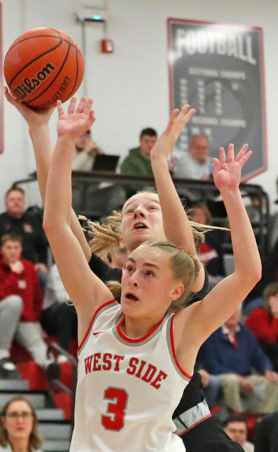 Rensselaer Central Bombers guard Courtney Mathew (31) shoots the ball over West Lafayette Red Devils guard Dylan Kastens (3) during the IHSAA basketball doubleheader, Thursday, Jan. 11, 2024, at West Lafayette High School in West Lafayette, Ind.
