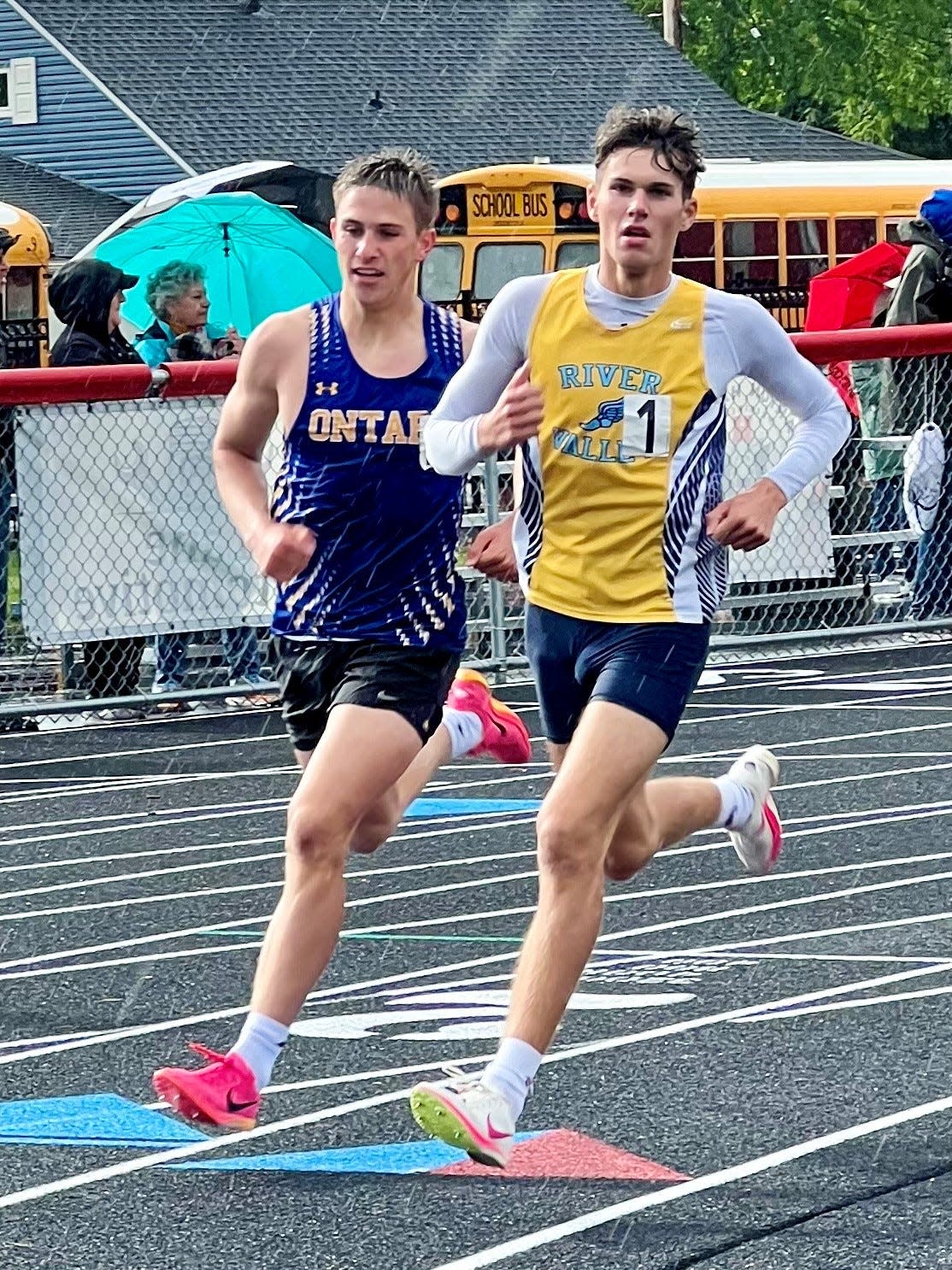 River Valley's Gabe Douce and Ontario's Jace Young compete in the boys 800 meters in the rain at Harding Stadium during the Mid Ohio Athletic Conference Track and Field Championships on Thursday.