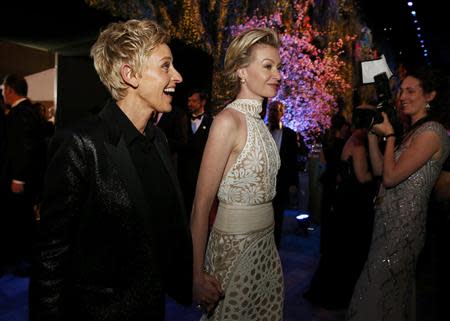 Academy Awards host Ellen Degeneres and her partner Portia de Rossi at the Governors Ball after the 86th Academy Awards in Hollywood, California March 2, 2014. REUTERS/Adrees Latif