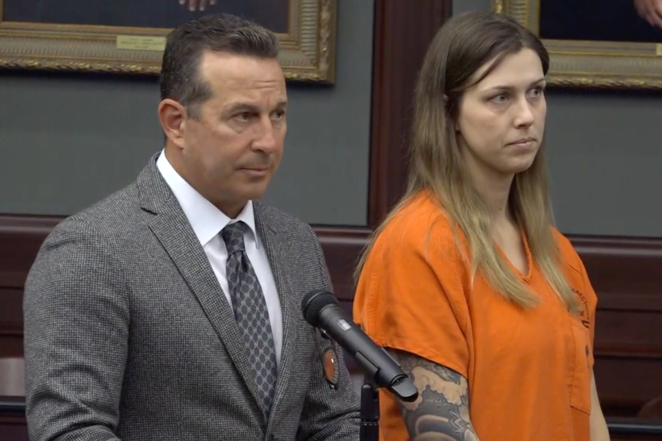 Defense attorney Jose Baez and Shanna Gardner listen to the judge during Friday's arraignment in the Duval County Courthouse. Gardner pleaded not guilty to charges in the murder plot of her ex-husband, Jared Bridegan.