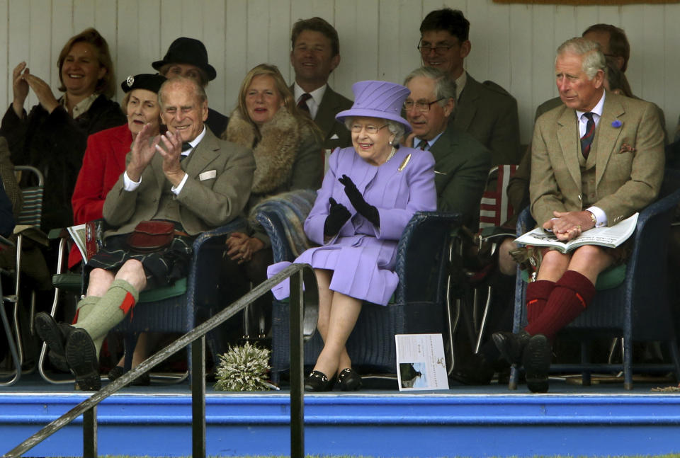 FILE - In this March 16, 2016 file photo, Britain's Queen Elizabeth II, Prince Philip and Prince Charles, right, attend the Braemar Royal Highland Gathering at the Princess Royal and Duke of Fife Memorial Park, Braemar, Scotland. Prince Philip, the irascible and tough-minded husband of Queen Elizabeth II who spent more than seven decades supporting his wife in a role that both defined and constricted his life, has died, Buckingham Palace said Friday, April 9, 2021. He was 99. (Andrew Milligan/PA via AP, File)