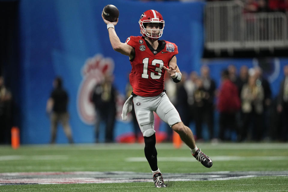 Georgia quarterback Stetson Bennett (13) passes the ball against Ohio State during the first half of the Peach Bowl NCAA college football semifinal playoff game, Saturday, Dec. 31, 2022, in Atlanta. (AP Photo/John Bazemore)