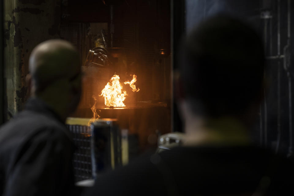 Steel workers operates a machine used in the manufacturing of 155 mm M795 artillery projectiles at the Scranton Army Ammunition Plant in Scranton, Pa., Thursday, April 13, 2023. One of the most important munitions of the Ukraine war comes from a historic factory in this city built by coal barons, where tons of steel rods are brought in by train to be forged into the artillery shells Kyiv can’t get enough of — and that the U.S. can’t produce fast enough. (AP Photo/Matt Rourke)