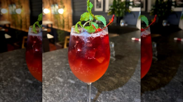 Trendy hibiscus cocktail with greenery