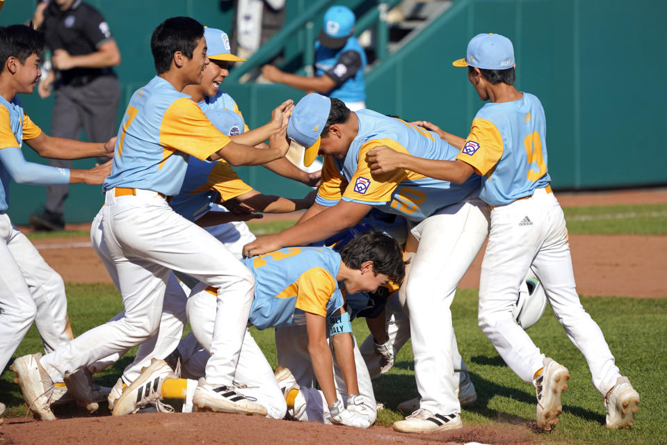 Members of the Honolulu Little League team celebrate their win against Curacao in the Little League World Series Championship baseball game in South Williamsport, Pa., Sunday, Aug. 28, 2022. Honolulu won 13-3. (AP Photo/Tom E. Puskar)