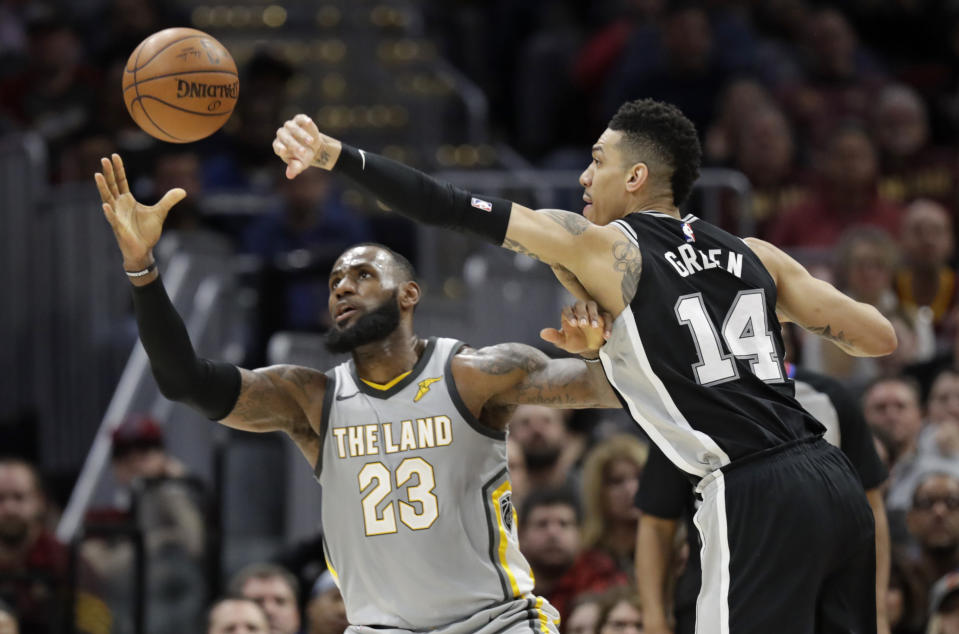 LeBron James and Danny Green battle for the ball. (AP)