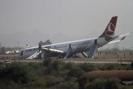 A Turkish Airlines plane lies on the field after it overshot the runway at Tribhuvan International Airport in Kathmandu March 4, 2015. According to local media all passengers were rescued. REUTERS/Navesh Chitrakar