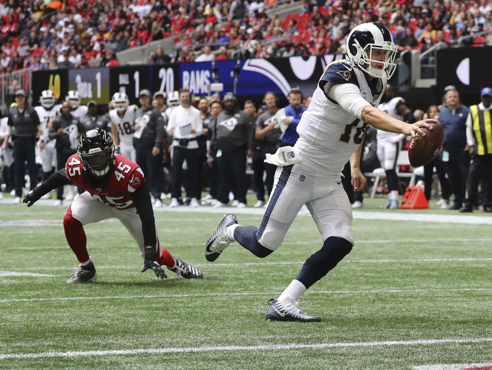 Los Angeles Rams quarterback Jared Goff, right, gets past Atlanta Falcons linebacker Deion Jones for a touchdown during the second half of an NFL football game Sunday, Oct, 20, 2019, in Atlanta. (Curtis Compton/Atlanta Journal-Constitution via AP)