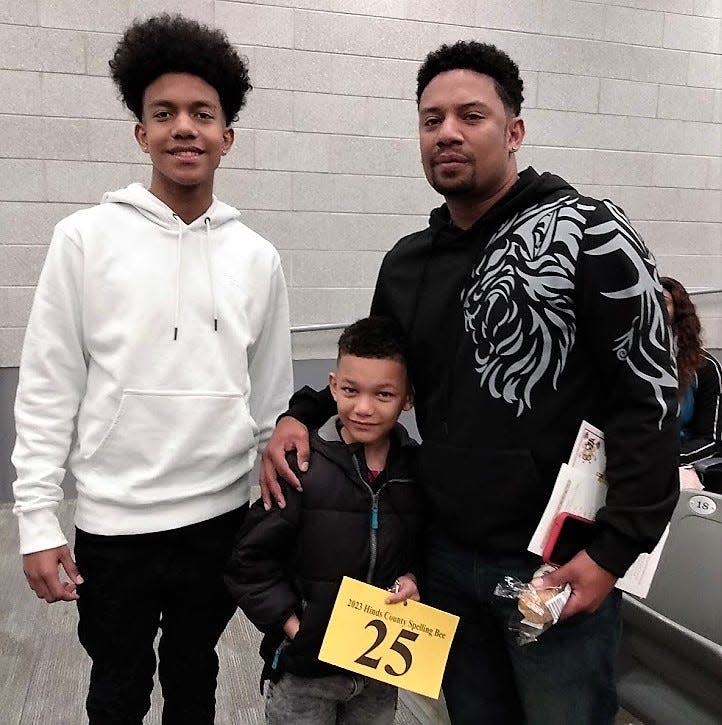 Gary Road Elementary second grader Jaden White was notable as the youngest competitor at Saturday’s Hinds County Spelling Bee. He is pictured with his older brother Jordan (left) and father Courtney (right).