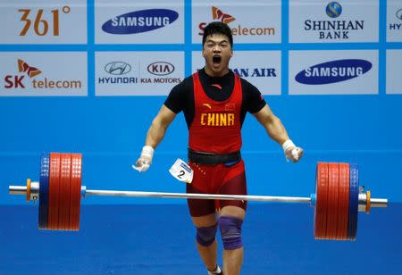 China's Tian Tao lifts 218kg in the clean and jerk segment to win the gold medal in the 85kg weightlifting competition at the Moonlight Festival Garden during the 17th Asian Games in Incheon September 24, 2014. REUTERS/Jason Reed