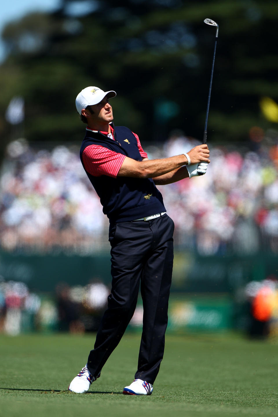 MELBOURNE, AUSTRALIA - NOVEMBER 20: Dustin Johnson of the U.S. Team plays his second shot on the first hole during the Day Four Singles Matches of the 2011 Presidents Cup at Royal Melbourne Golf Course on November 20, 2011 in Melbourne, Australia. (Photo by Ryan Pierse/Getty Images)