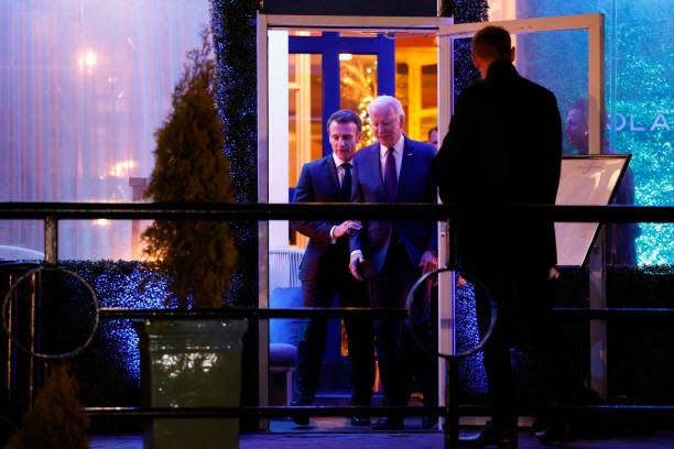 French president Emmanuel Macron (L) chats with US president Joe Biden as they leave Fiola Mare restaurant after a private dinner in Washington, DC, on 30 November 2022 (AFP via Getty Images)