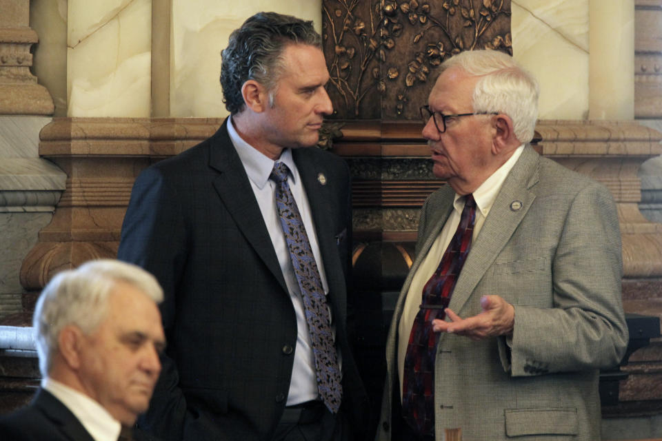 Kansas Senate President Ty Masterson, left, R-Andover, confers with Vice President Richard Wilborn, R-McPherson, during the Senate's session, Thursday, March 14, 2024, at the Statehouse in Topeka, Kan. Republican lawmakers are close to being able to enact a ban on gender-affirming care for minors over an expected veto by Democratic Gov. Laura Kelly. (AP Photo/John Hanna)