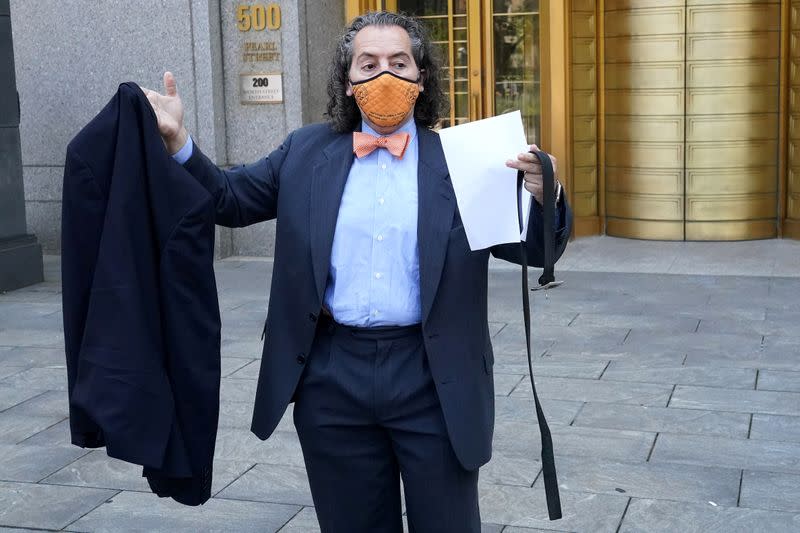 Attorney for Michael Cohen, Jeffrey Levine holds Cohen's belt and jacket up as he tells the media Cohen has been remanded outside Federal Court in the Manhattan Borough of New York City
