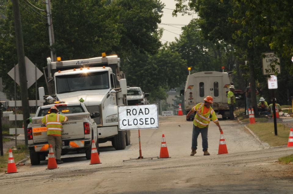 Workers closing up for the day on one of the many streets in Somerset Borough undergoing construction of underground lines.