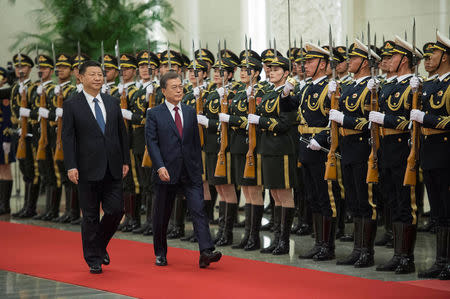 South Korean President Moon Jae-In and Chinese President Xi Jinping review the Chinese honour guard during a welcome ceremony at the Great Hall of the People in Beijing, China December 14, 2017. REUTERS/Nicolas Asfouri/Pool