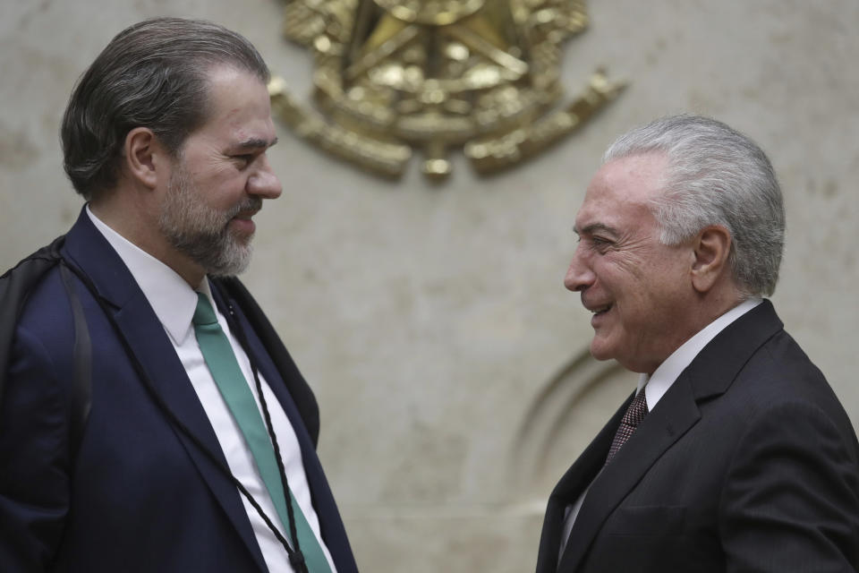 Brazil's President Michel Temer, right, talks with the President of the Supreme Court Dias Toffoli, during a ceremony in honor of the 30th anniversary of the Brazilian Constitution, iat the Supreme Court in Brasilia, Brazil, Thursday, Oct. 4, 2018. Brazil celebrates on October 5 the third anniversary of its constitution, which was promulgated in 1988 after the process of re-democratization of the country. (AP Photo/Eraldo Peres)