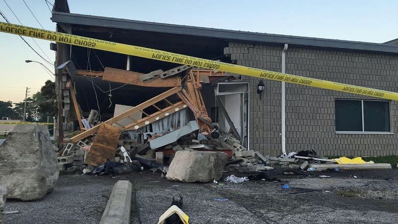 1 dead as car slams through wall at west end machine shop