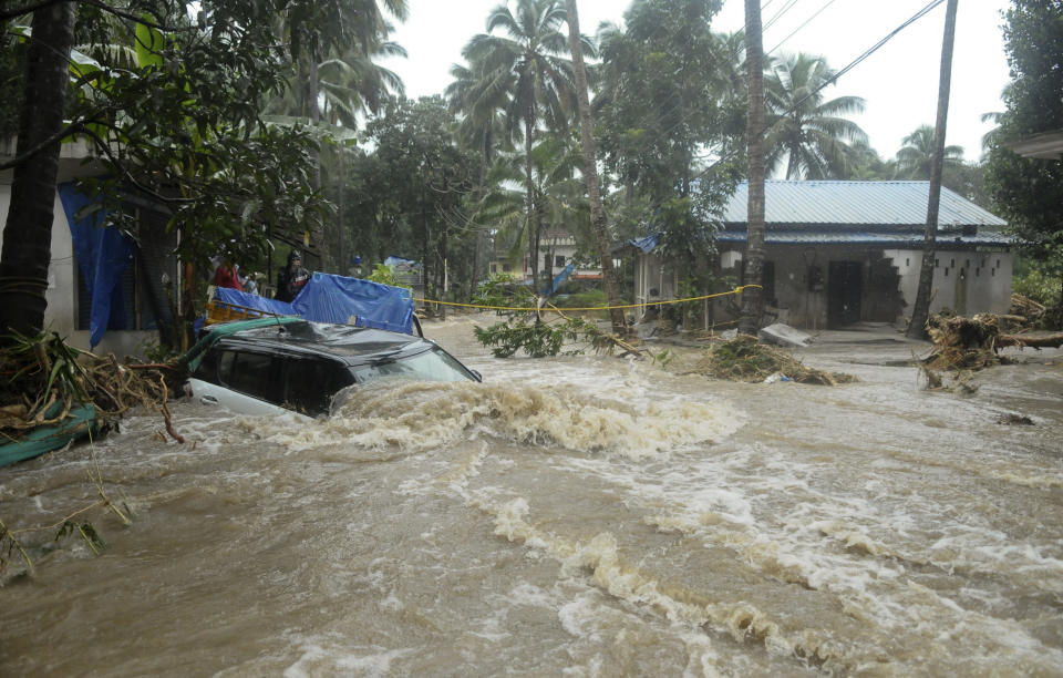 A car is submerged as roads and houses are engulfed in water following heavy rain and landslide in Kozhikode, Kerala state, India, Thursday, Aug. 9, 2018. Landslides triggered by heavy monsoon rains have killed more than a dozen people in southern India, cutting off road links and submerging several villages. (AP Photo)