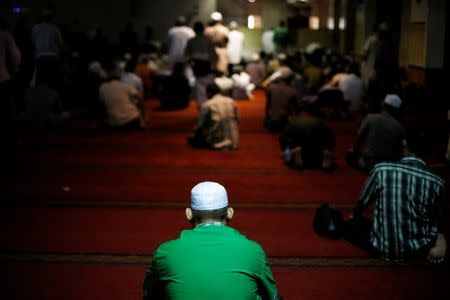 People wait to pray at a mosque in Jakarta, Indonesia, June 7, 2018. Picture taken June 7, 2018. REUTERS/Beawiharta