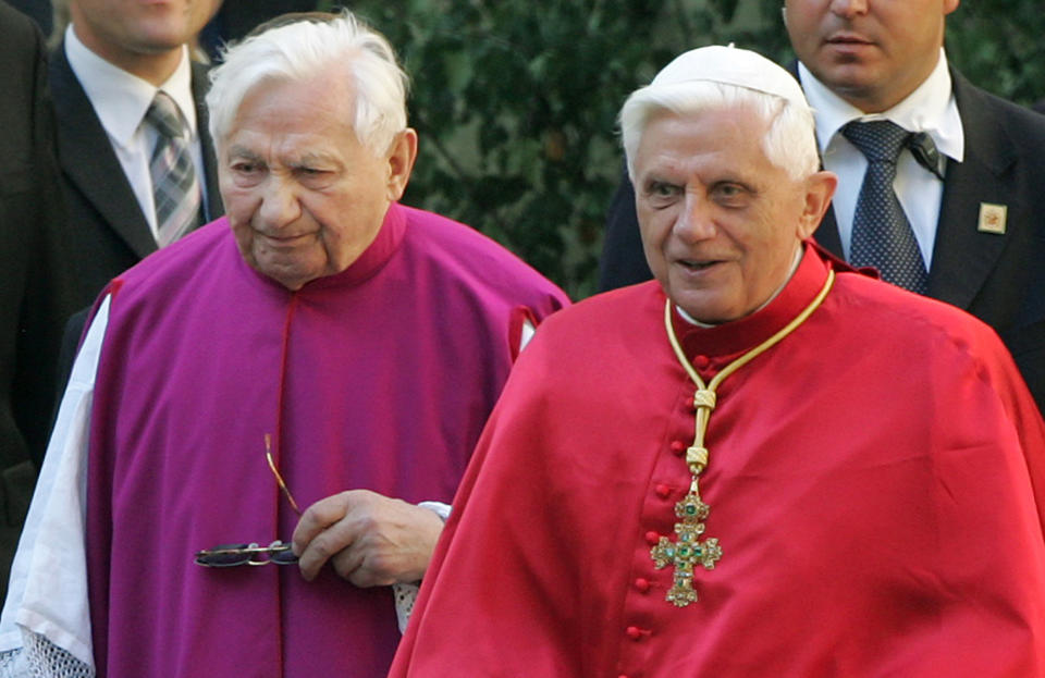 FILE - In this Sept. 13, 2006 file picture Pope Benedict XVI, right, walks with his brother priest Georg Ratzinger in Regensburg, southern Germany. The Vatican says Emeritus Pope Benedict is in Germany to be with his brother, who is in poor health. Benedict on Thursday arrived in Regensburg, Germany, where his brother, the Rev. Georg Ratzinger, lives, and where “he will spend the necessary time,” the Vatican said in a statement. (AP Photo/Diether Endlicher,File)