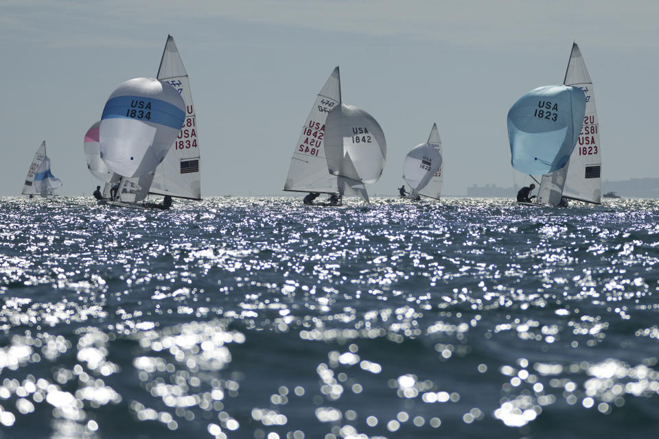 Stu McNay and Lara Dallman-Weiss, center, campaign in the mixed-gender 470 category at U.S. Sailing Olympic Trials, off the coast of Miami Beach, Fla., Friday, Jan. 12, 2024. McNay is returning for his fifth Olympics and teaming up with Dallman-Weiss, who competed in the women's 470 in the Tokyo Games, in the new mixed-gender category. (AP Photo/Rebecca Blackwell)