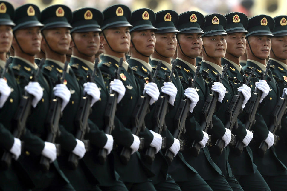 Members of China's People's Liberation Army (PLA) Rocket Force march in formation during a parade to commemorate the 70th anniversary of the founding of Communist China in Beijing, Tuesday, Oct. 1, 2019. Trucks carrying weapons including a nuclear-armed missile designed to evade U.S. defenses rumbled through Beijing as the Communist Party celebrated its 70th anniversary in power with a parade Tuesday that showcased China's ambition as a rising global force. (AP Photo/Mark Schiefelbein)