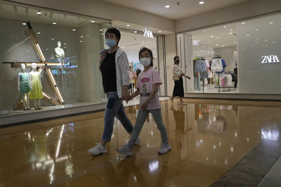 A woman and child wearing masks pass by a Zara store in Beijing on Thursday, June 3, 2021. The Chinese government has accused H&M, Nike, Zara and other brands of importing unsafe or poor quality children's clothes and other goods, adding to headaches for foreign companies after Beijing attacked them over complaints about possible forced labor in the country's northwest. (AP Photo/Ng Han Guan)