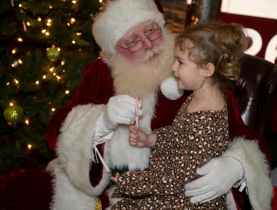 Lainey Way, 4, gets a candy cane from Santa during this year's Streetsboro Holiday Lighting Ceremony.