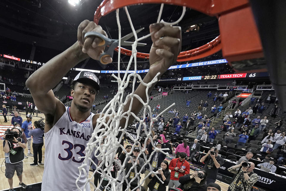 Kansas forward David McCormack cuts the net after an NCAA college basketball championship game against Texas Tech in the Big 12 Conference tournament in Kansas City, Mo., Saturday, March 12, 2022. Kansas won 74-65. (AP Photo/Charlie Riedel)