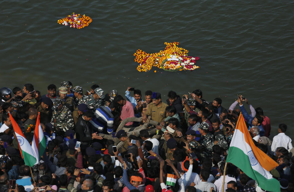 Mourners gather for the cremation of Central Reserve Police Force (CRPF) soldier Mahesh Yadav, who was killed in Thursday bombing in Kashmir, on the outskirts of Tudihar village, some 56 kilometers east of Prayagraj, Uttar Pradesh state, India, Saturday, Feb. 16, 2019. The death toll from a car bombing on a paramilitary convoy in Indian-controlled Kashmir has climbed to at least 40, becoming the single deadliest attack in the divided region's volatile history, security officials said Friday. (AP Photo/ Rajesh Kumar Singh)