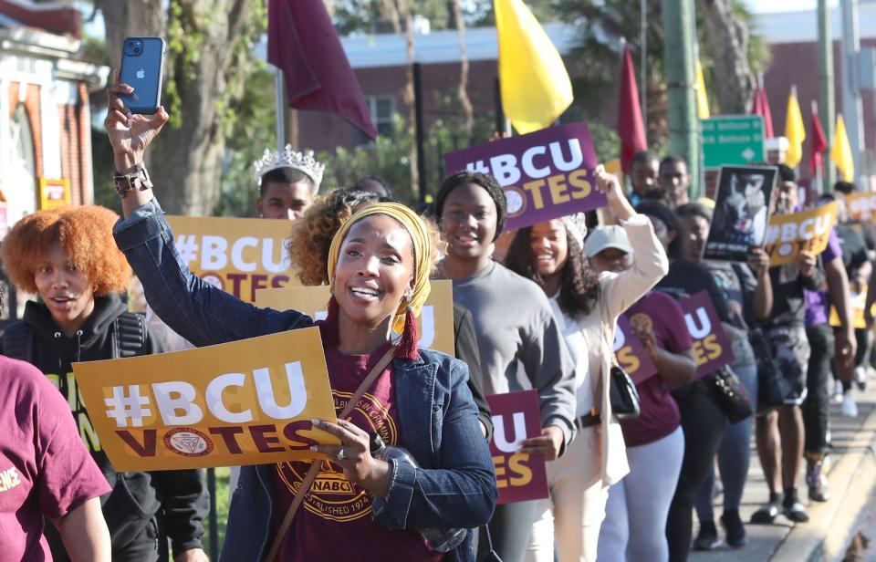 Bethune-Cookman University students march along Mary McLeod Bethune Boulevard on Wednesday from White Hall Chapel on the B-CU campus to the Midtown Cultural & Educational Center to participate in early voting.