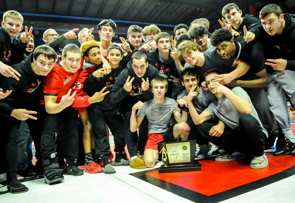 Delsea celebrates with the NJSIAA trophy after defeating Warren Hills in the state Group 3 wrestling finals at Rutgers' University Jersey Mike's Arena in Piscataway, NJ on Sunday Feb. 12, 2023.