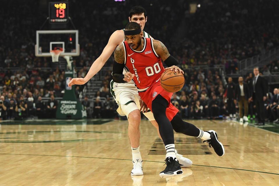 MILWAUKEE, WISCONSIN - NOVEMBER 21: Carmelo Anthony #00 of the Portland Trail Blazers drives around Ersan Ilyasova #7 of the Milwaukee Bucks during the first half of a game at Fiserv Forum on November 21, 2019 in Milwaukee, Wisconsin. NOTE TO USER: User expressly acknowledges and agrees that, by downloading and or using this photograph, User is consenting to the terms and conditions of the Getty Images License Agreement. (Photo by Stacy Revere/Getty Images)