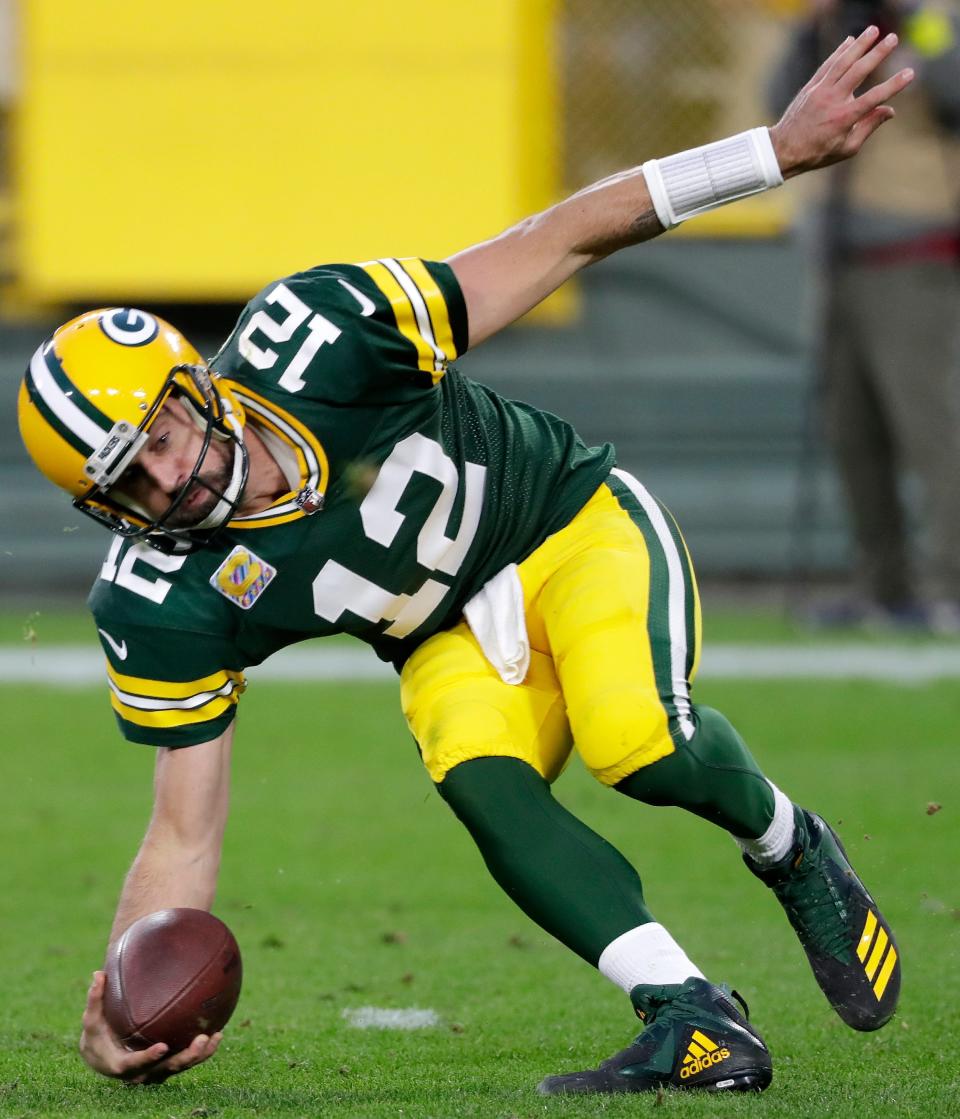 Green Bay Packers quarterback Aaron Rodgers (12) loses his balance while scrammbling under pressure against the New England Patriots during their football game on Sunday, October 2, 2022 at Lambeau Field in Green Bay, Wis. The Packers defeated the Patriots 27-24 in overtime.Wm. Glasheen USA TODAY NETWORK-Wisconsin

Apc Pack Vs Patriots 27411 100222wag