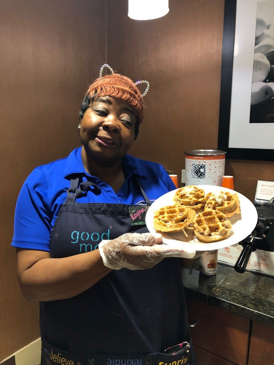 Regina Triche smiles with her cat ears showing off one of her many waffle variations.