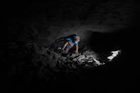 Andres Gomez works inside an amber mine near the community of Jotolchen II in Chiapas state, Mexico, Thursday, Sept. 10, 2020. The 11-year-old said that before the new coronavirus pandemic hit, he attended school and then would spend a couple of hours mining after class, but since the school closed in March he is spending entire days mining. (AP Photo/Eduardo Verdugo)