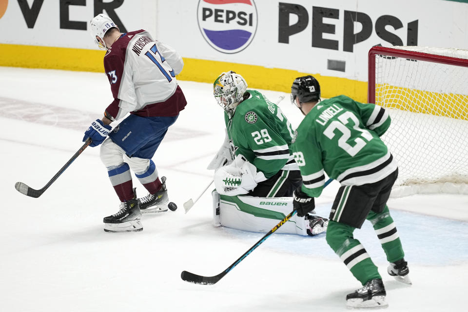 Dallas Stars goaltender Jake Oettinger (29) and defenseman Esa Lindell (23) defend against a shot, and pressure at the net from Colorado Avalanche right wing Valeri Nichushkin (13), during the third period in Game 2 of an NHL hockey Stanley Cup second-round playoff series in Dallas, Thursday, May 9, 2024. (AP Photo/Tony Gutierrez)