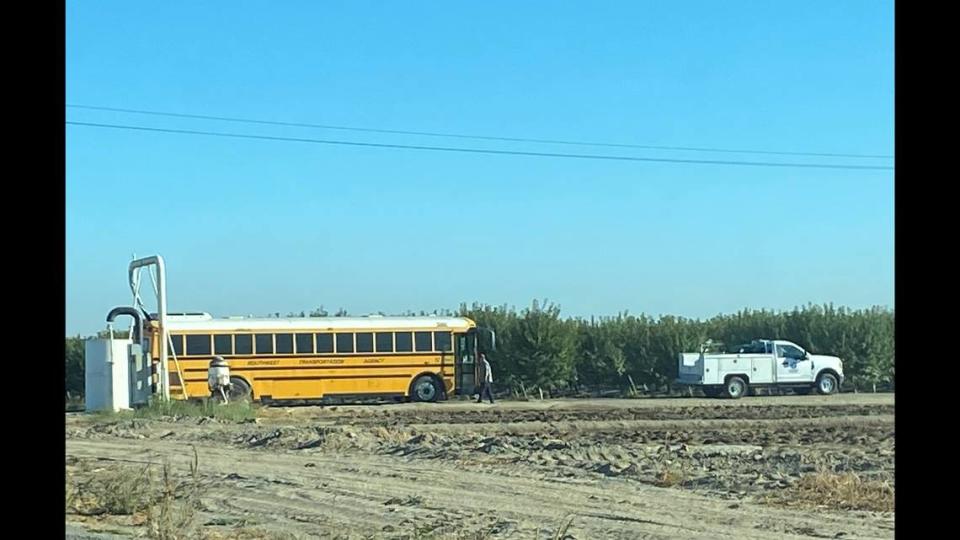 Fresno County Cal Fire crews responded to a report of a bus on fire as it carried 20 children to school near Riverdale on Thursday, Sept. 28, 2022. A truck towed it down a dirt road.