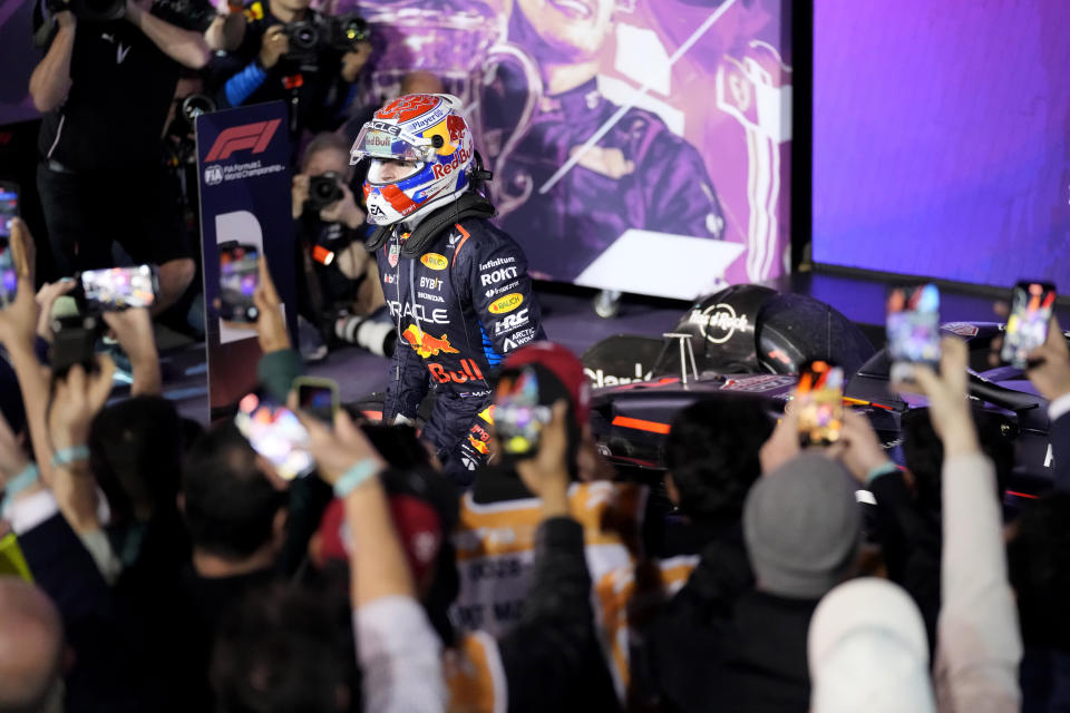 Red Bull driver Max Verstappen of the Netherlands jumps out of his car after placing first during the Formula One Bahrain Grand Prix at the Bahrain International Circuit in Sakhir, Bahrain, Saturday, March 2, 2024. (AP Photo/Darko Bandic)