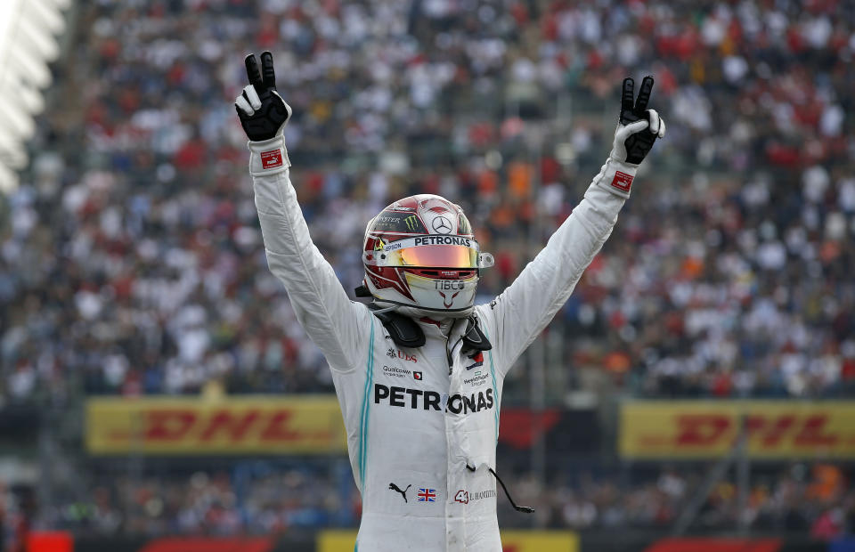 In this Oct. 27, 2019 photo, Mercedes driver Lewis Hamilton, of Britain, celebrates after his victory in the Formula One Mexico Grand Prix auto race at the Hermanos Rodriguez racetrack in Mexico City. “This is a race I’ve wanted to win for some time. It came together nicely,” Hamilton said after climbing out of his car with a wave to the massive crowds. (AP Photo/Eduardo Verdugo)