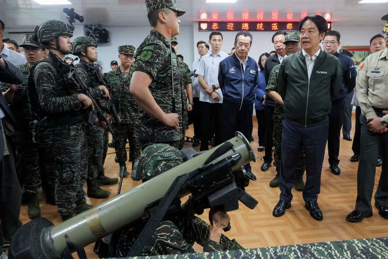 FILE PHOTO: Taiwanese President Lai Ching-te studies a rocket launcher during his visit to a military camp in Taoyuan