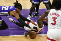 Sacramento Kings forward Richaun Holmes, left, and Toronto Raptors forward Chris Boucher go for the ball during the first quarter of an NBA basketball game in Sacramento, Calif., Friday, Jan. 8, 2021. (AP Photo/Rich Pedroncelli)