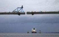 The tanker carrying the first shipment of U.S. shale gas passes the new crossing under construction as as it travels up the Forth to dock at Grangemouth in Scotland, Britain September 27, 2016. REUTERS/Russell Cheyne