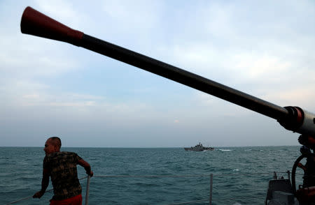 A rescue team member stands on deck of Sikuda navy ship during a rescue operation of Lion Air's flight JT610 airplane at the north coast of Karawang, Indonesia, November 2, 2018. REUTERS/Beawiharta